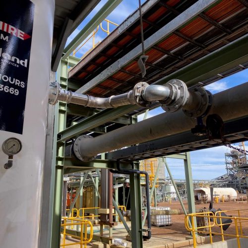 Detailed view of industrial piping connected to a Cleveland Compressors air receiver tank, highlighting precision engineering and seamless integration at the facility.