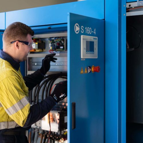 Man checking an air compressor unit